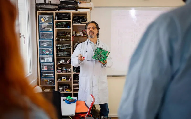 Students performing CAN Bus communication experiments on embedded systems kits