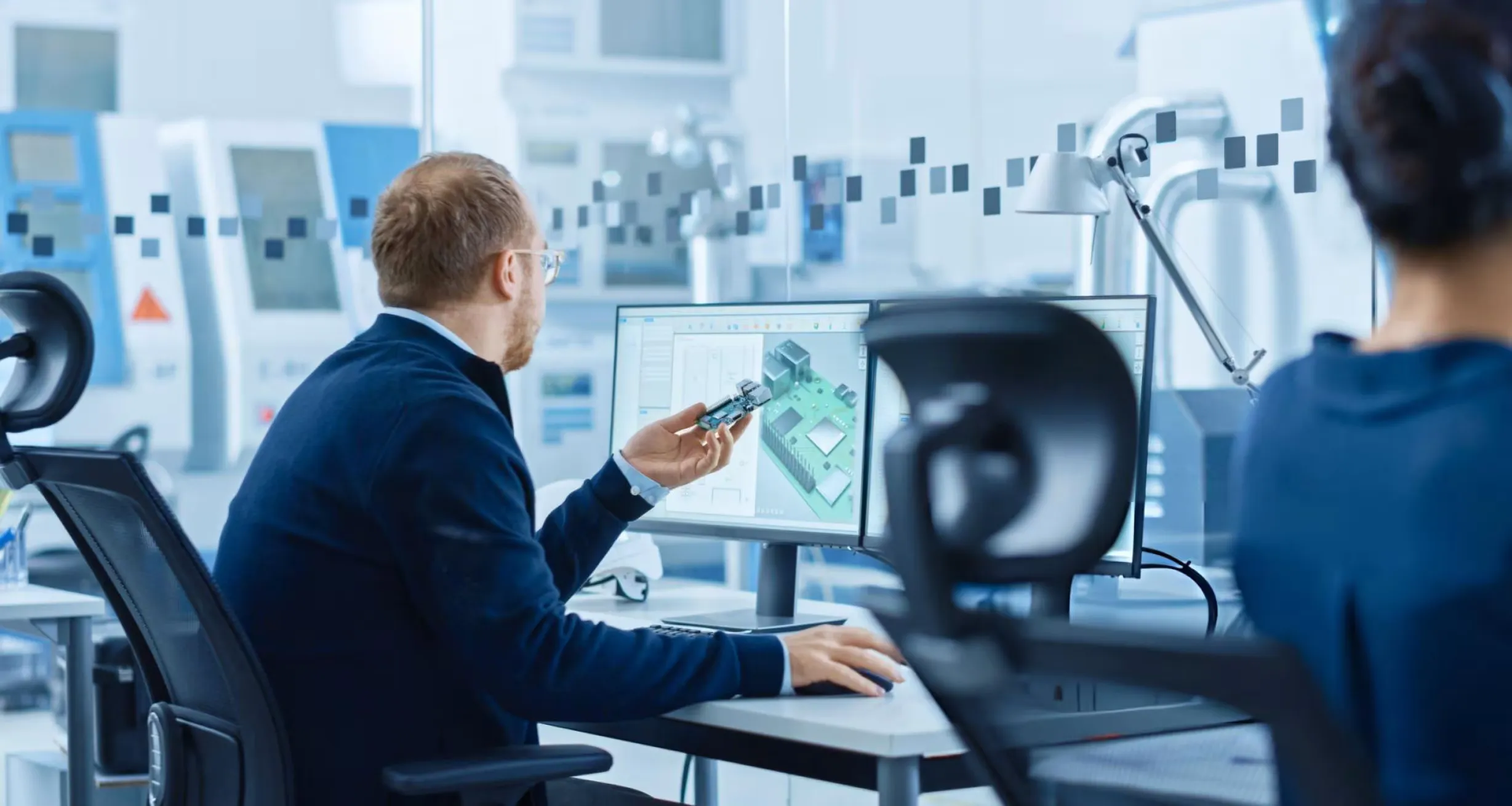 Professionals collaborating on embedded system design during IoT product development.